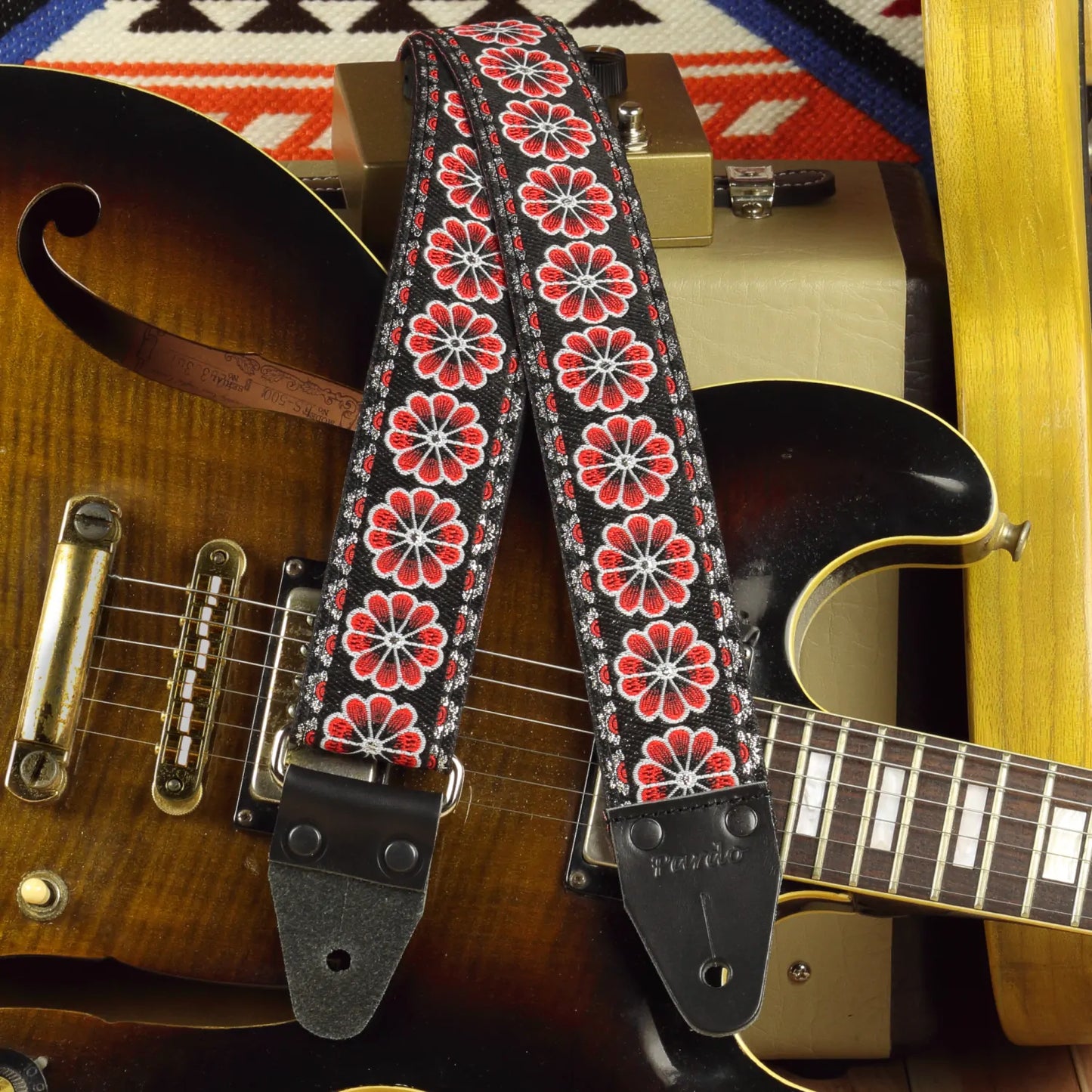 Detail of the Red Flowers strap complementing a semi-hollow body electric guitar
