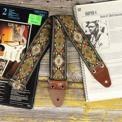Front view of the Red Fly guitar strap showing its woven design and dark brown leather ends.