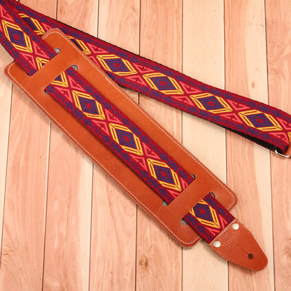 Red and yellow jacquard guitar strap for electric or acoustic guitar - paired with a leather guitar strap pad for better coverage and extra comfort