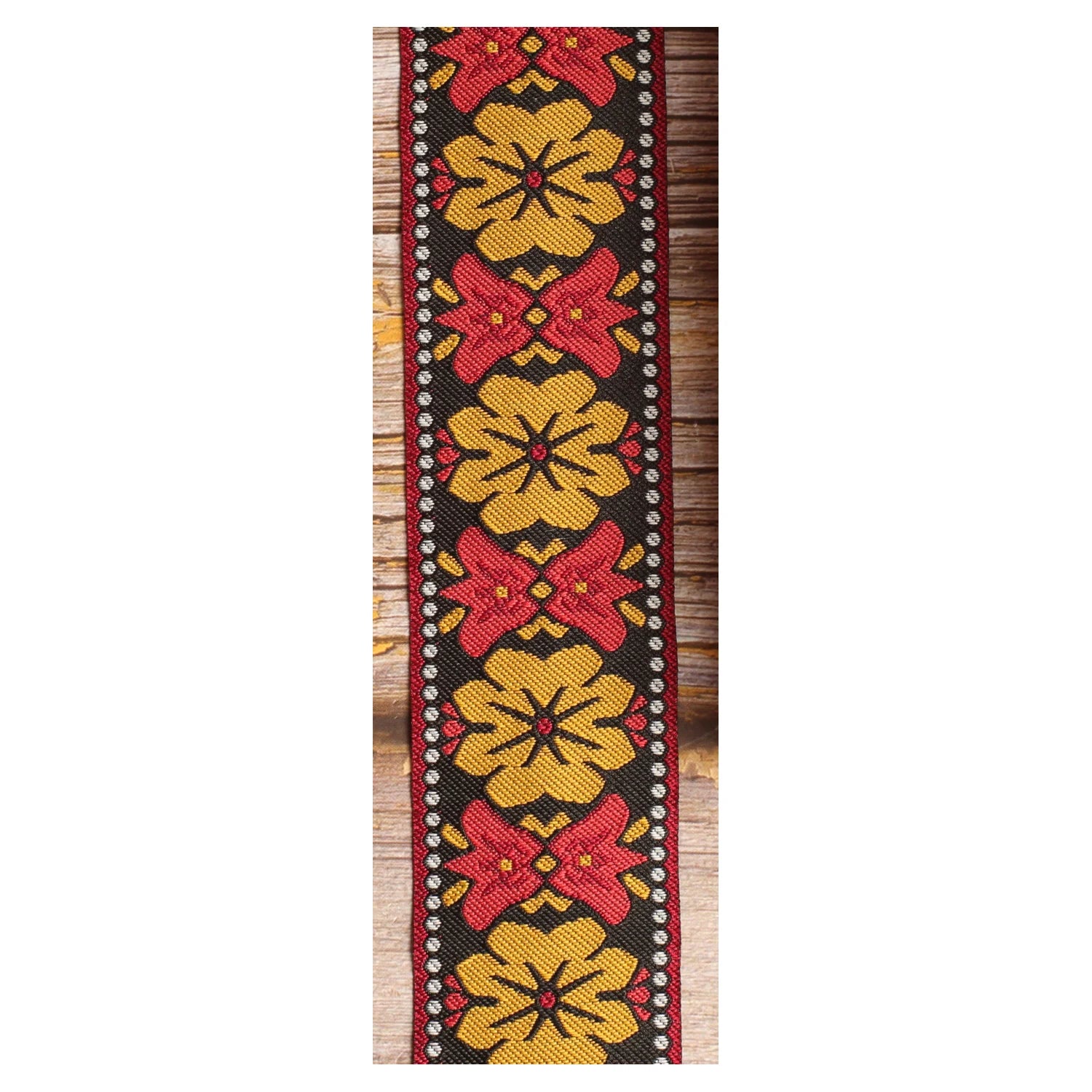 Retro Bell woven guitar strap featuring oversized mustard motifs and contrasting red bell-shaped details.