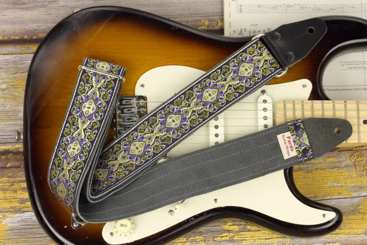 Vintage style woven guitar strap with a psychedelic design in vibrant gold and lilac colors.