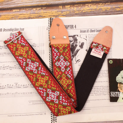 Guitar strap made with a jacquard fabric with baroque and bohemian style, with red colors, white and ocre