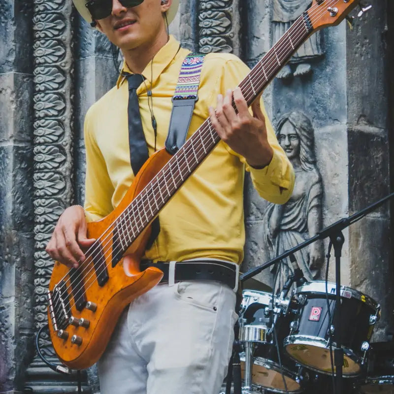 Retro style bassist playing bass guitar on stage