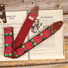 Roses guitar strap on a sheet music book with Red Burgundy suede backing