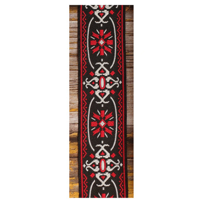 Close-up of the Blackdoor guitar strap design with repeated red and white geometric motifs against a black background.
