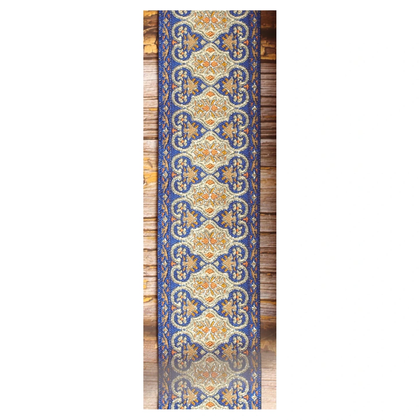 Close-up of the Blue Gothian guitar strap design featuring symmetrical blue, ivory, gold and orange ornamental details.