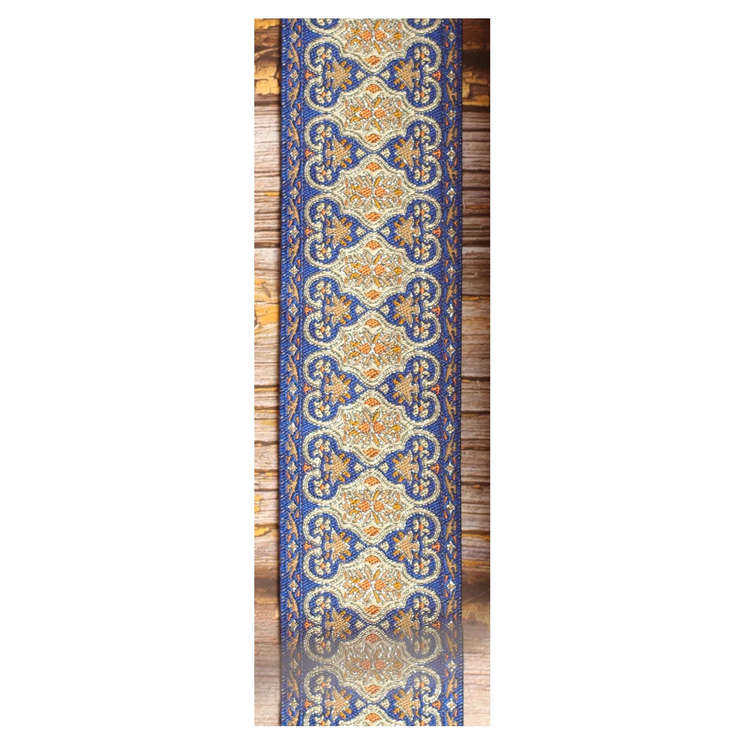 Close-up of the Blue Gothian guitar strap design featuring symmetrical blue, ivory, gold and orange ornamental details.