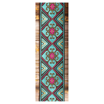 Close-up of the Blue Ocean guitar strap design with turquoise geometric sections, ornamental curves and pink and golden details.