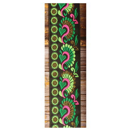 Close-up of the Swann Green guitar strap design with flowing green and pink motifs and golden details on a black background.