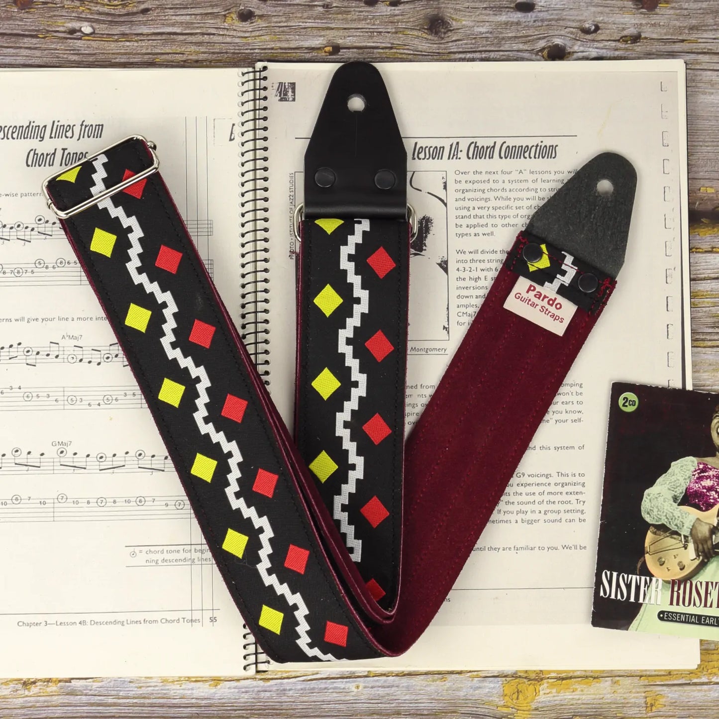 The Diamonds famous guitar strap inspired by George Harrison's strap, shown with customizable suede backing.