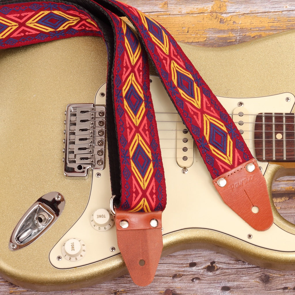 Tribal inspired Red Chief guitar strap in bold colors paired with a Fender Stratocaster Gold Sparkle
