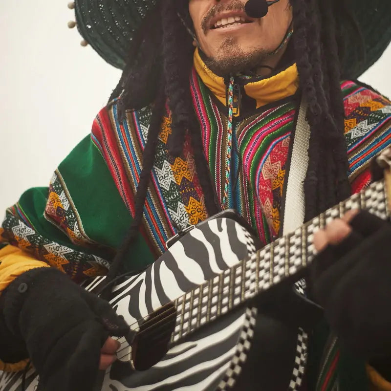 Tribal style guitarist playing guitar with native inspired clothing