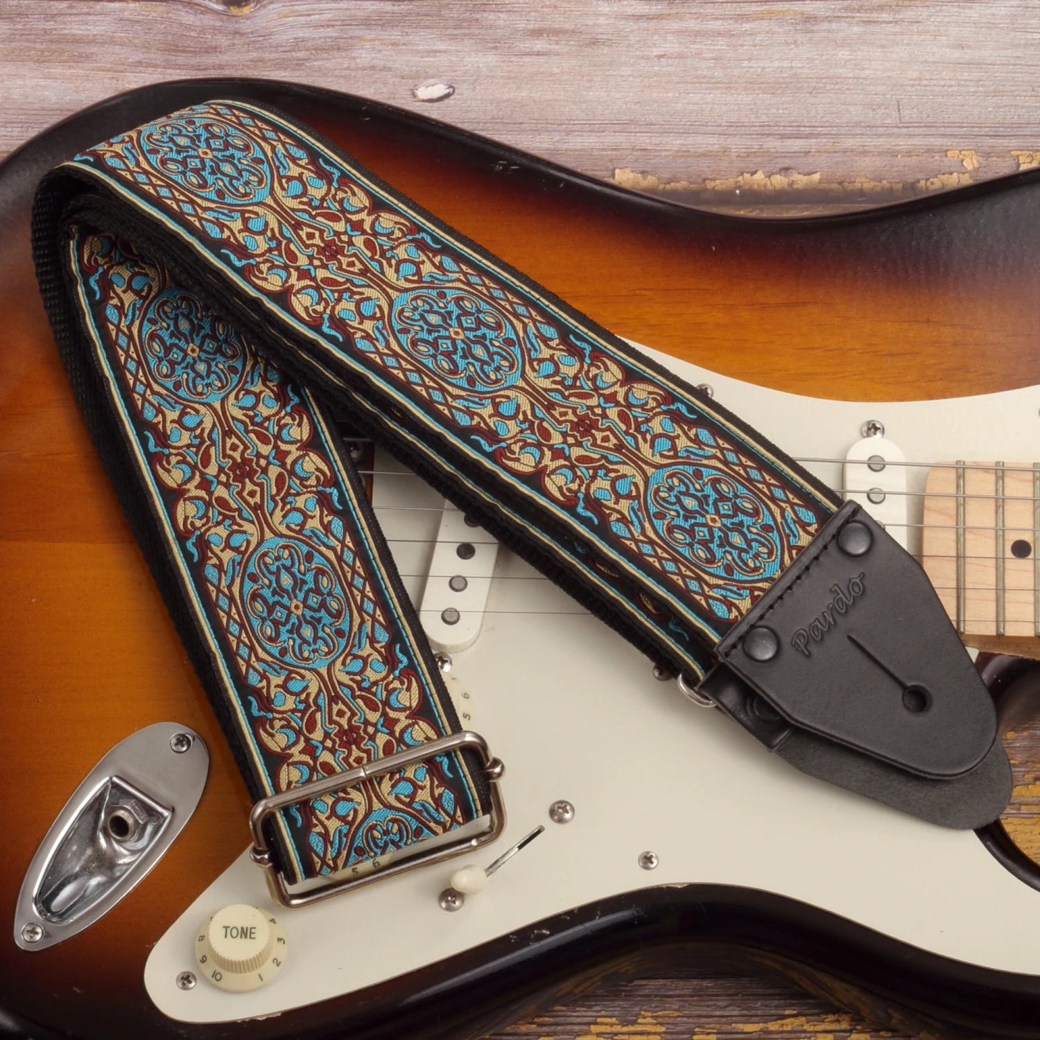 Blue Bloom wide long floral psychedelic guitar strap in blue and ochre with Fender Stratocaster Gold Sparkle