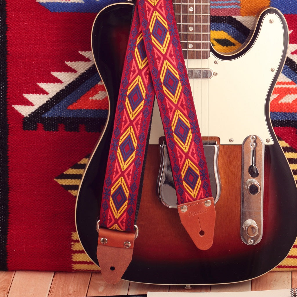 Woven jacquard Red Chief guitar strap for musicians, paired with a Sunburst Fender Telecaster electric guitar